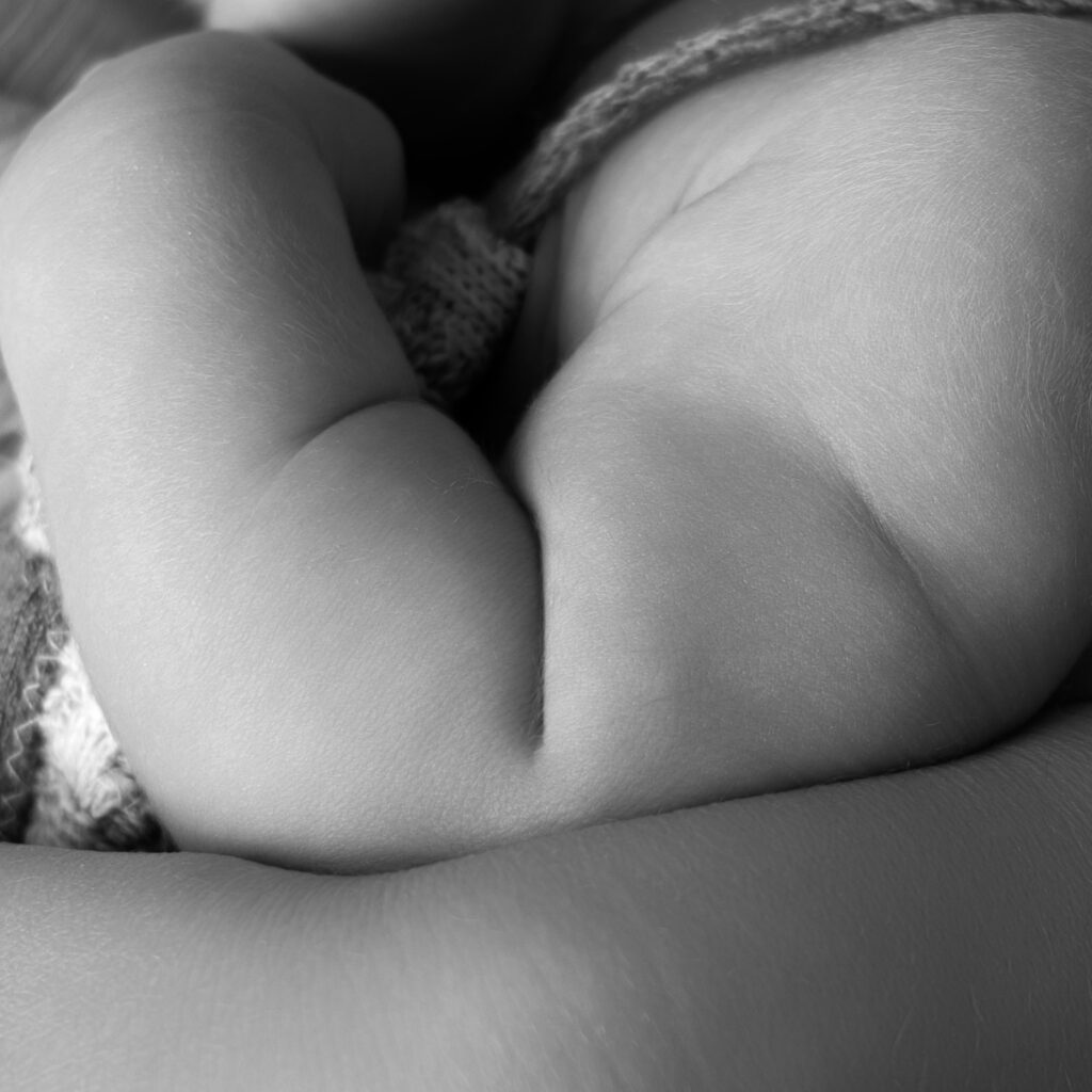 Detail of a baby arm that shows the rolls and represents strenghth.